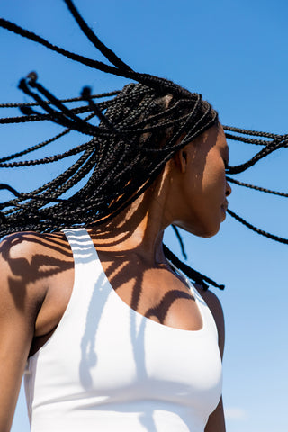 Woman with braided hair against a blue sky