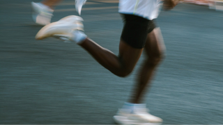 Blurred image of a person running on a track
