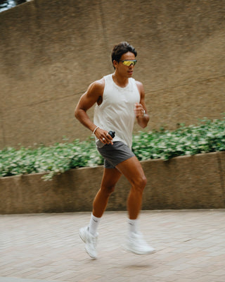 Man running with supplement drink in hand